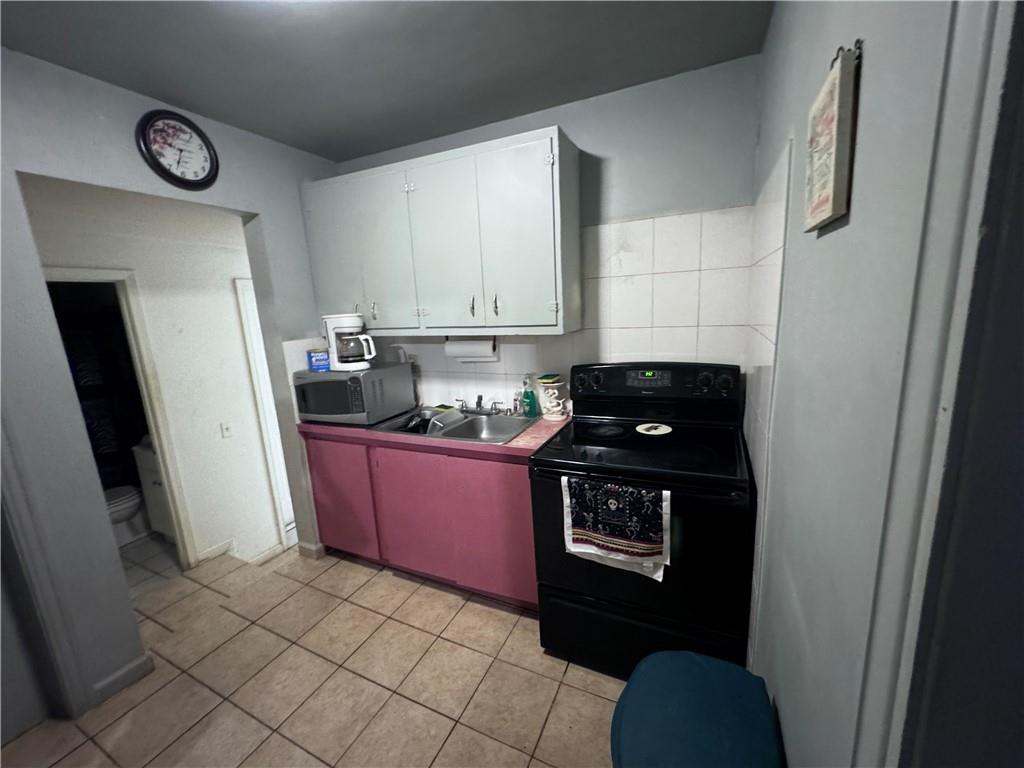 209 Denham Street Thomaston, GA 30286 - Photo 7 of 13 a kitchen with a refrigerator stove and a sink