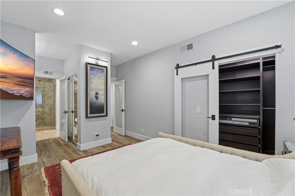 5 Baycrest Place Dana Point, CA 92629 - Photo 14 of 23 a bedroom with a bed and a flat screen tv