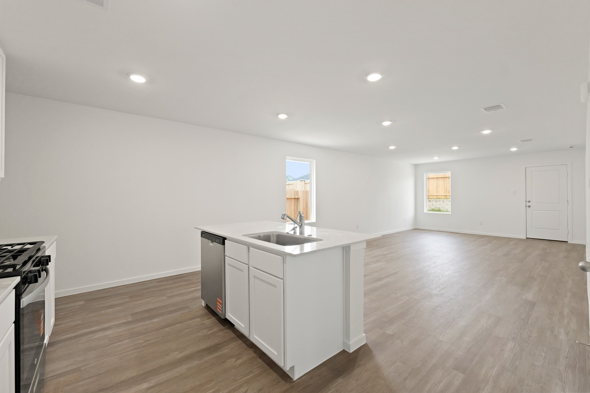 22710 Ravine Edge Court Hockley, TX 77447 - Photo 4 of 23 a view of a kitchen island wooden floor and window