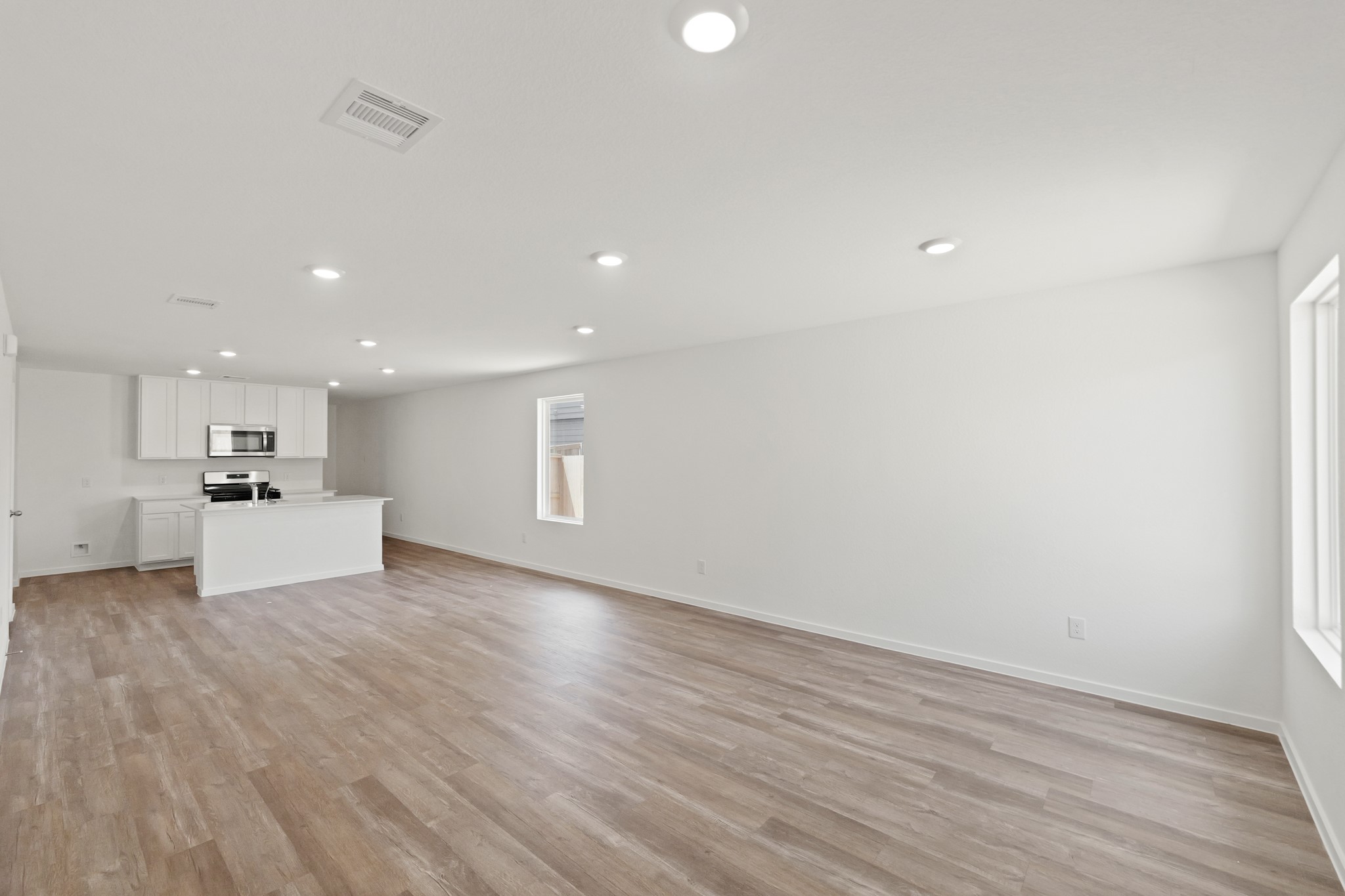 22710 Ravine Edge Court Hockley, TX 77447 - Photo 6 of 23 a view of kitchen with refrigerator and microwave