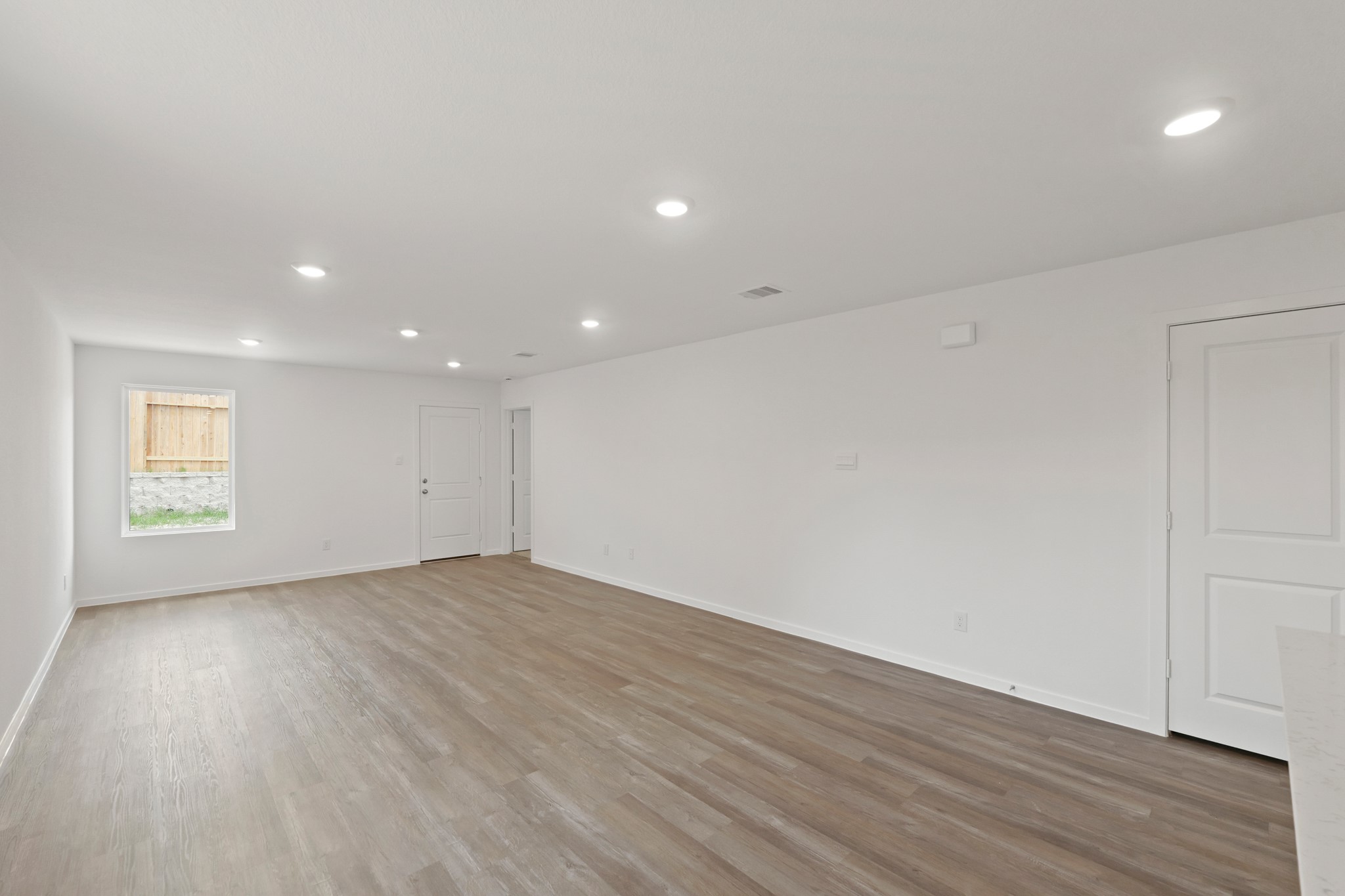 22710 Ravine Edge Court Hockley, TX 77447 - Photo 8 of 23 an empty room with wooden floor and windows