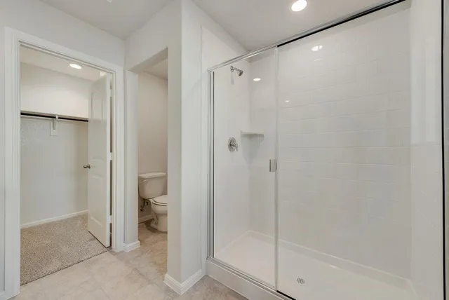 a bathroom with a shower and a glass door