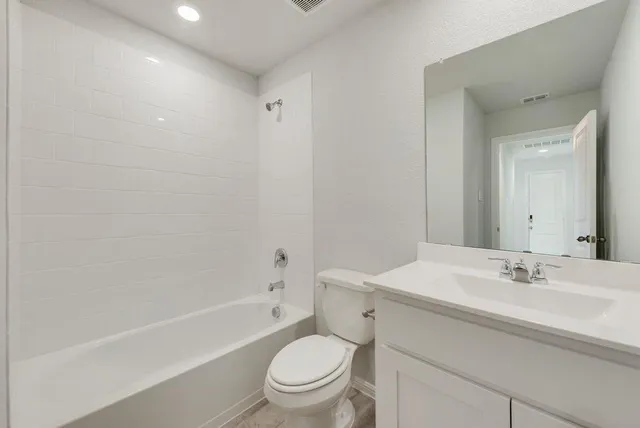 a bathroom with a sink a toilet and a bathtub