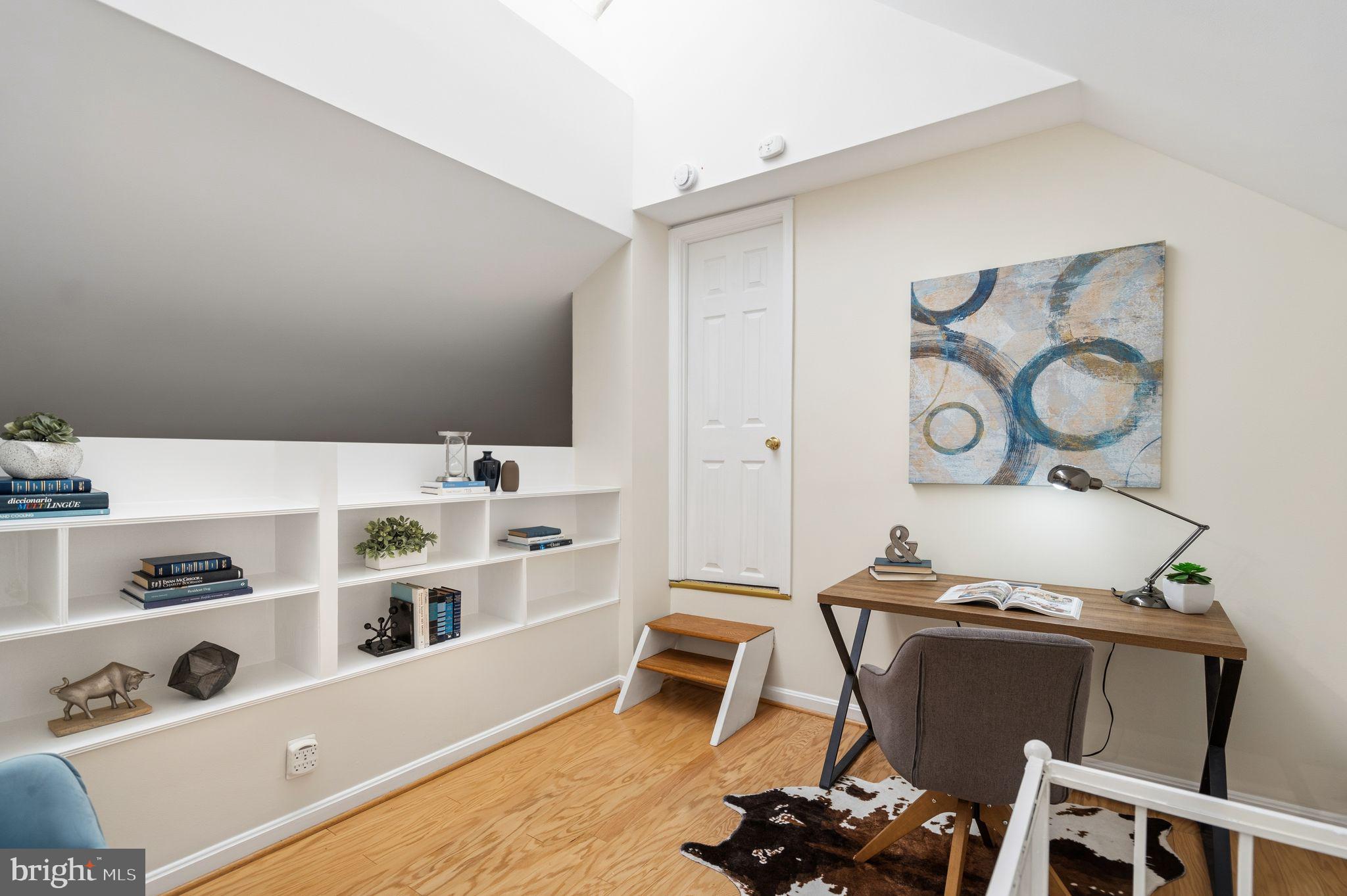 3225 Grace Street Northwest, Unit 226 Washington, DC 20007 - Photo 33 of 45 a living room with hard wood flooring and white walls