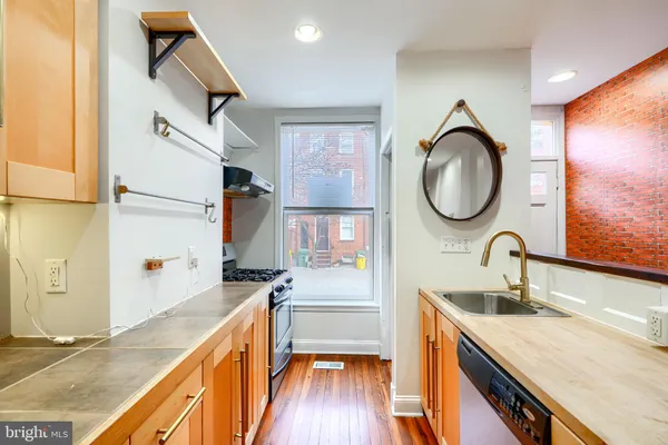 a kitchen with a sink and a refrigerator