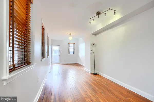 a view of a hallway view with wooden floor and staircase