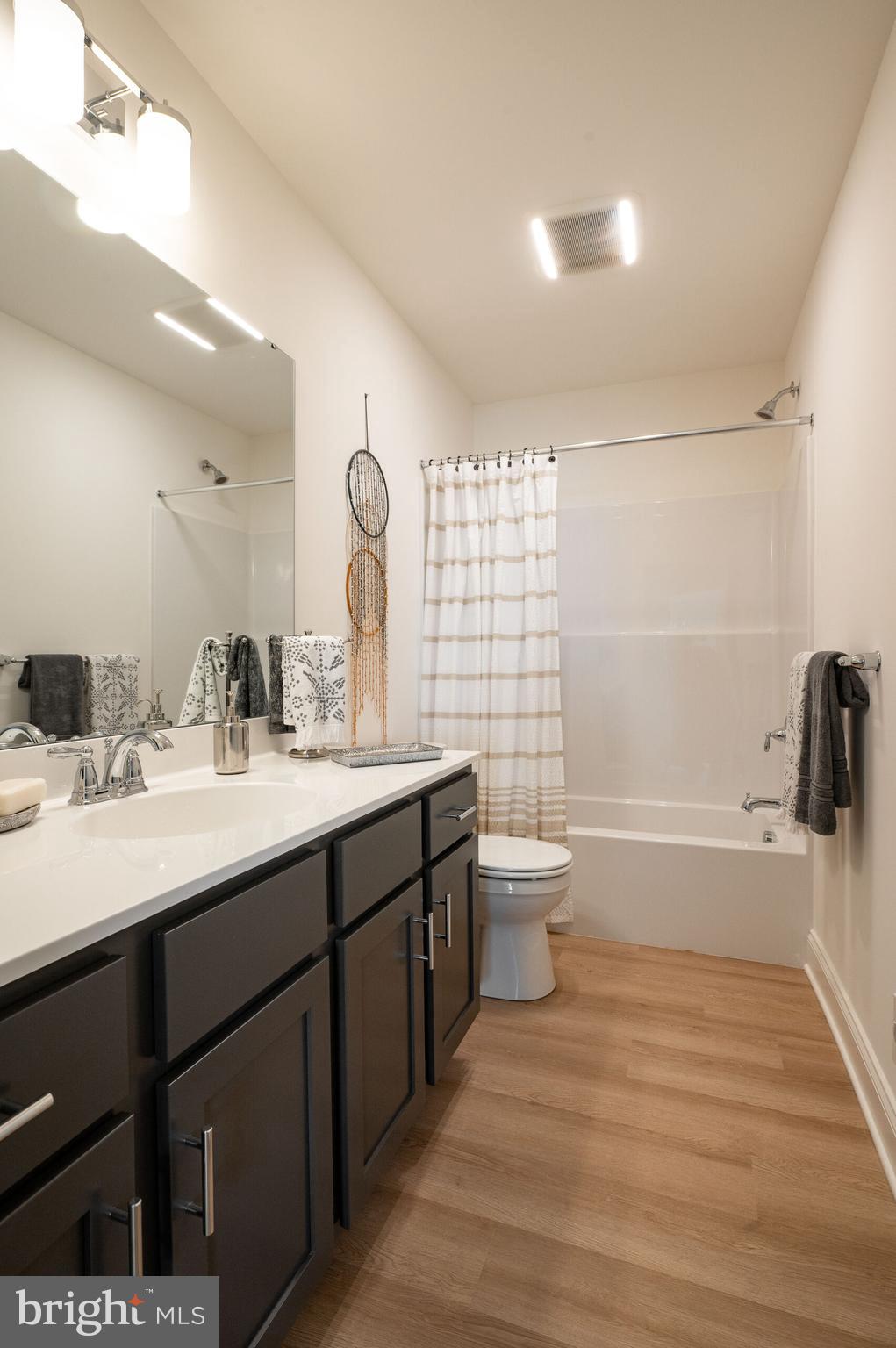 0 Old Orch Road, Unit LAUREL Strasburg, PA 17579 - Photo 15 of 15 a bathroom with a double vanity sink toilet mirror and shower