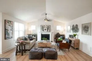 a living room with furniture fireplace and a large window