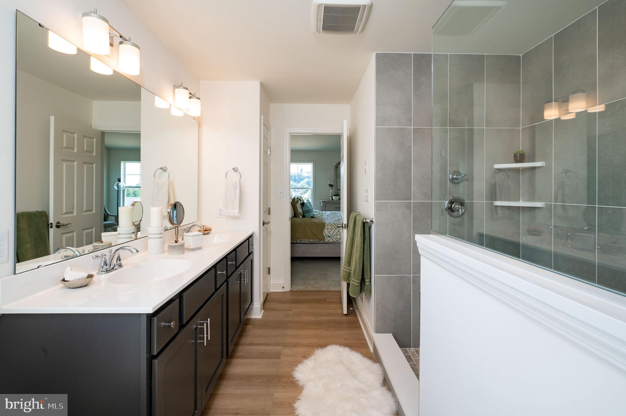 0 Old Orch Road, Unit LAUREL Strasburg, PA 17579 - Photo 10 of 15 a bathroom with a double vanity sink a toilet and shower