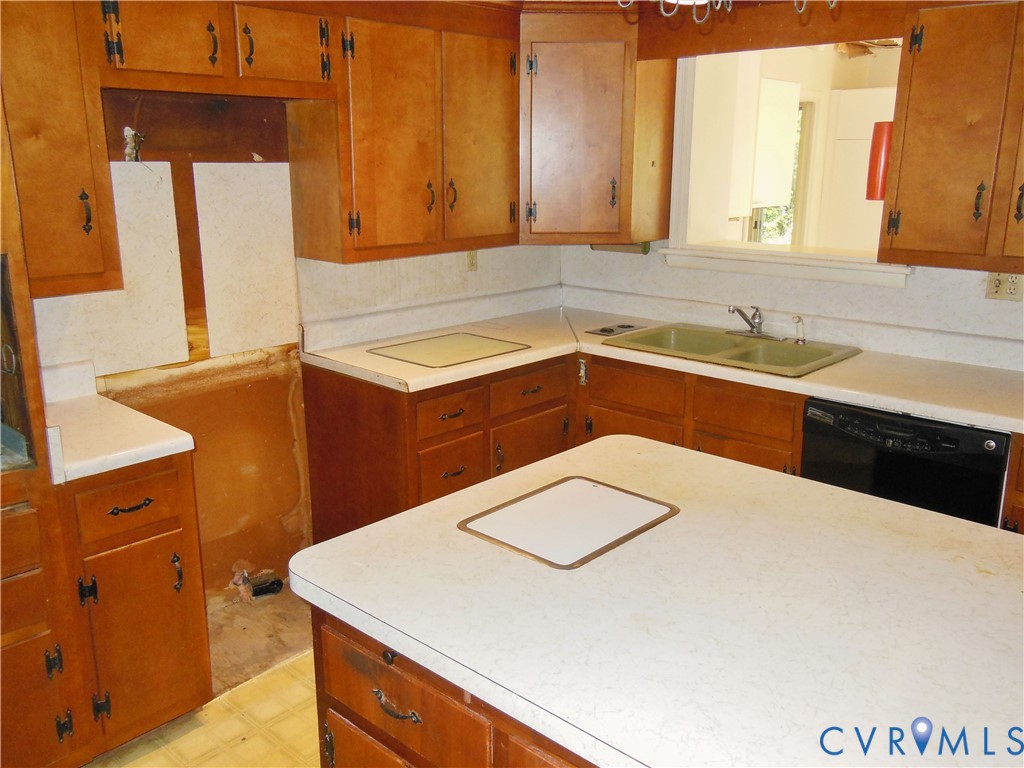 8218 Overbury Road Richmond, VA 23227 - Photo 8 of 37 a kitchen with a sink a stove and refrigerator