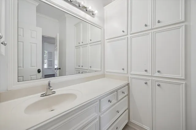 a bathroom with a sink and cabinets