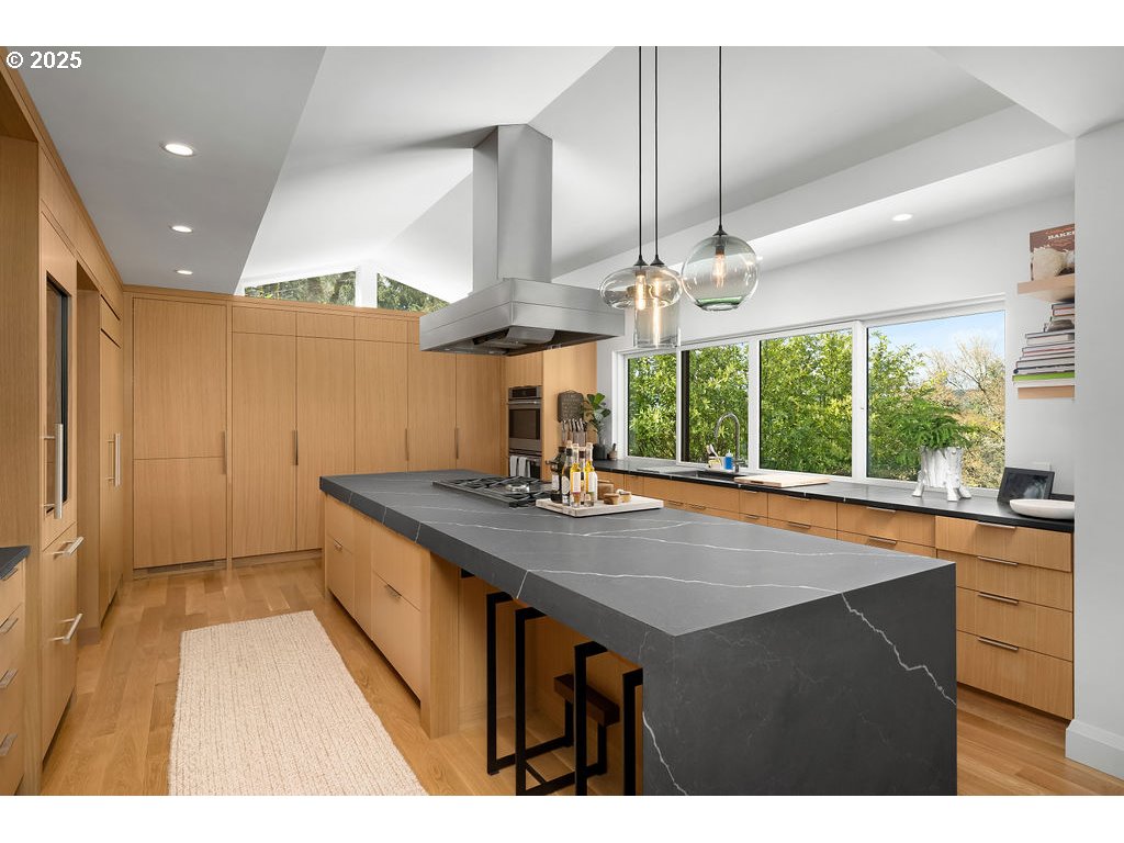 2627 Park Road Lake Oswego, OR 97034 - Photo 12 of 47 a kitchen with stainless steel appliances granite countertop a sink a stove and a wooden floors
