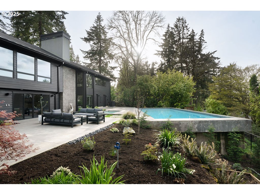 2627 Park Road Lake Oswego, OR 97034 - Photo 45 of 47 a view of swimming pool with outdoor seating and trees in the background