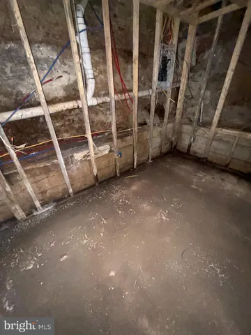 a view of an empty room with wooden floor and windows