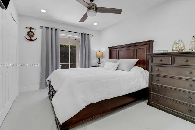 a bedroom with a bed and ceiling fan
