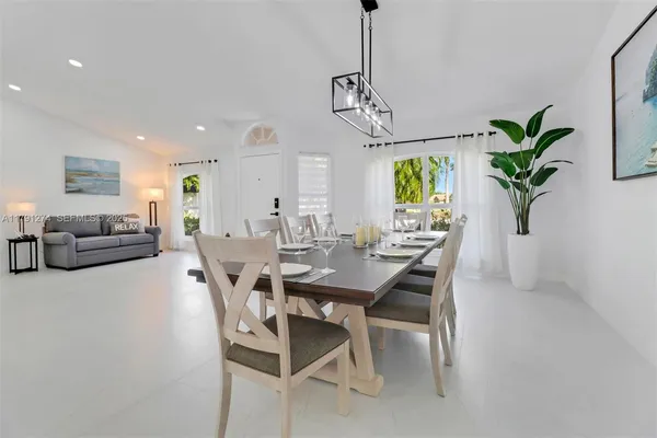 a view of a dining room with furniture window and flowerpot