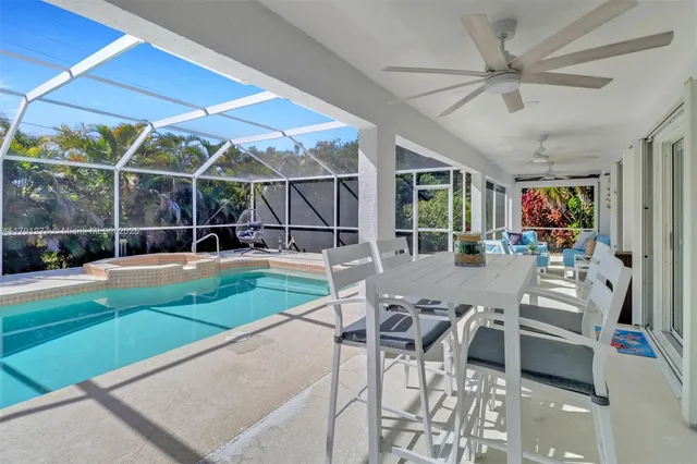 a view of a patio with a table and chairs under an umbrella