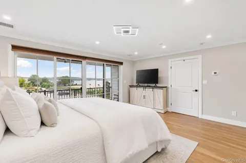 a spacious bedroom with a large bed and a flat screen tv