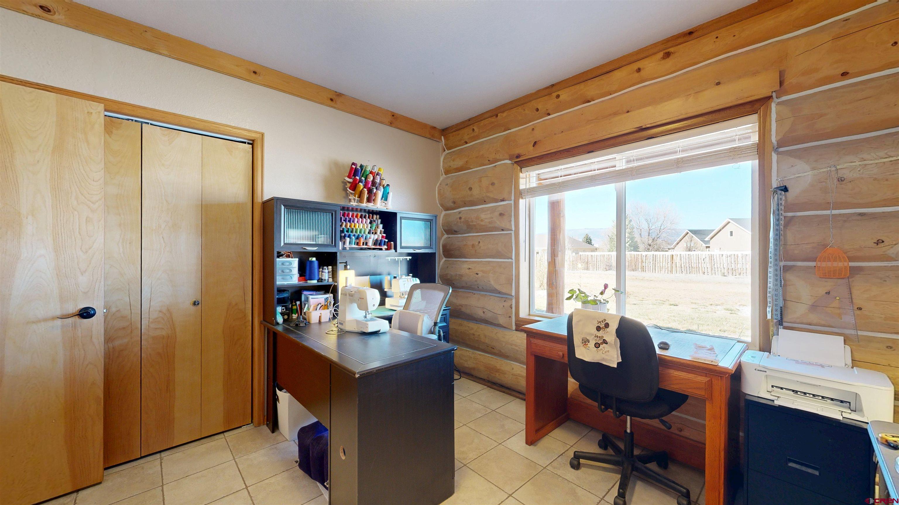 2083 Pioneer Road Delta, CO 81416 - Photo 21 of 43 a view of a workspace with furniture and a window