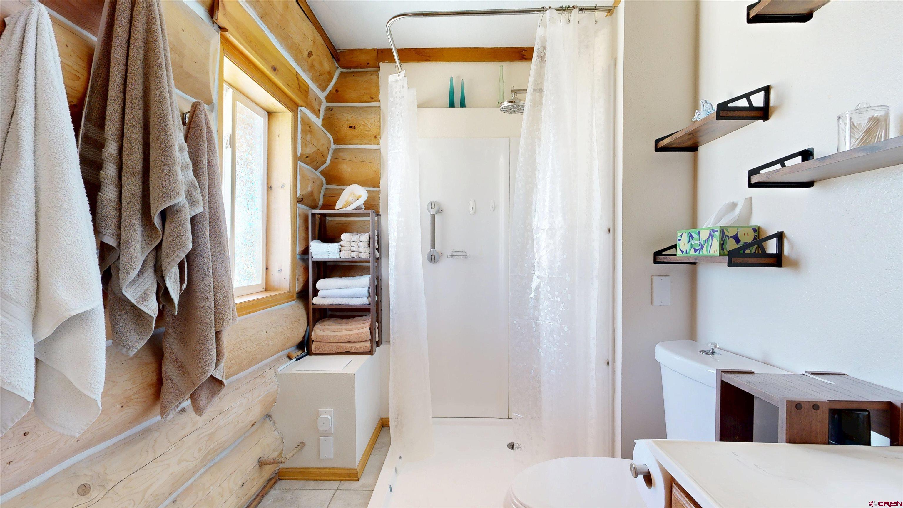 2083 Pioneer Road Delta, CO 81416 - Photo 29 of 43 a bathroom with a bathtub and a shower