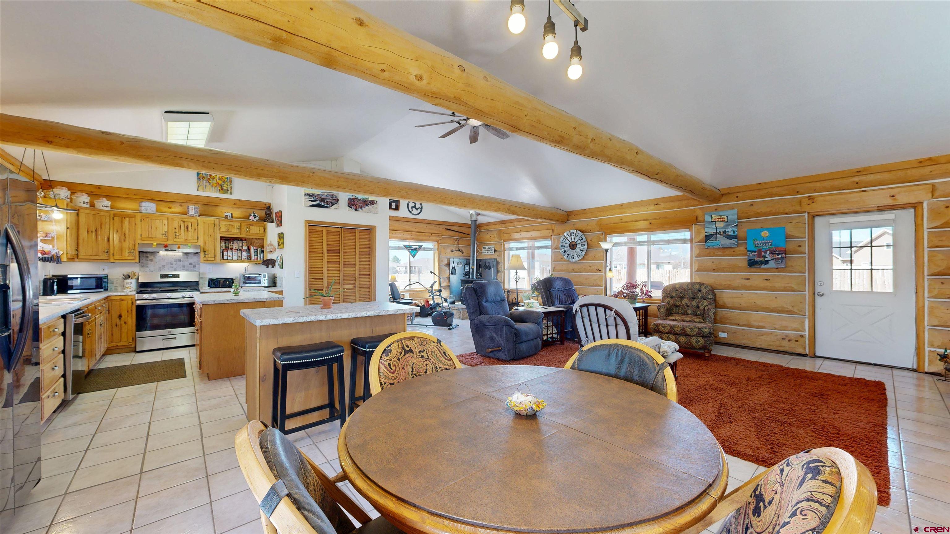 2083 Pioneer Road Delta, CO 81416 - Photo 5 of 43 a very nice looking dining room with kitchen island furniture a chandelier and kitchen view
