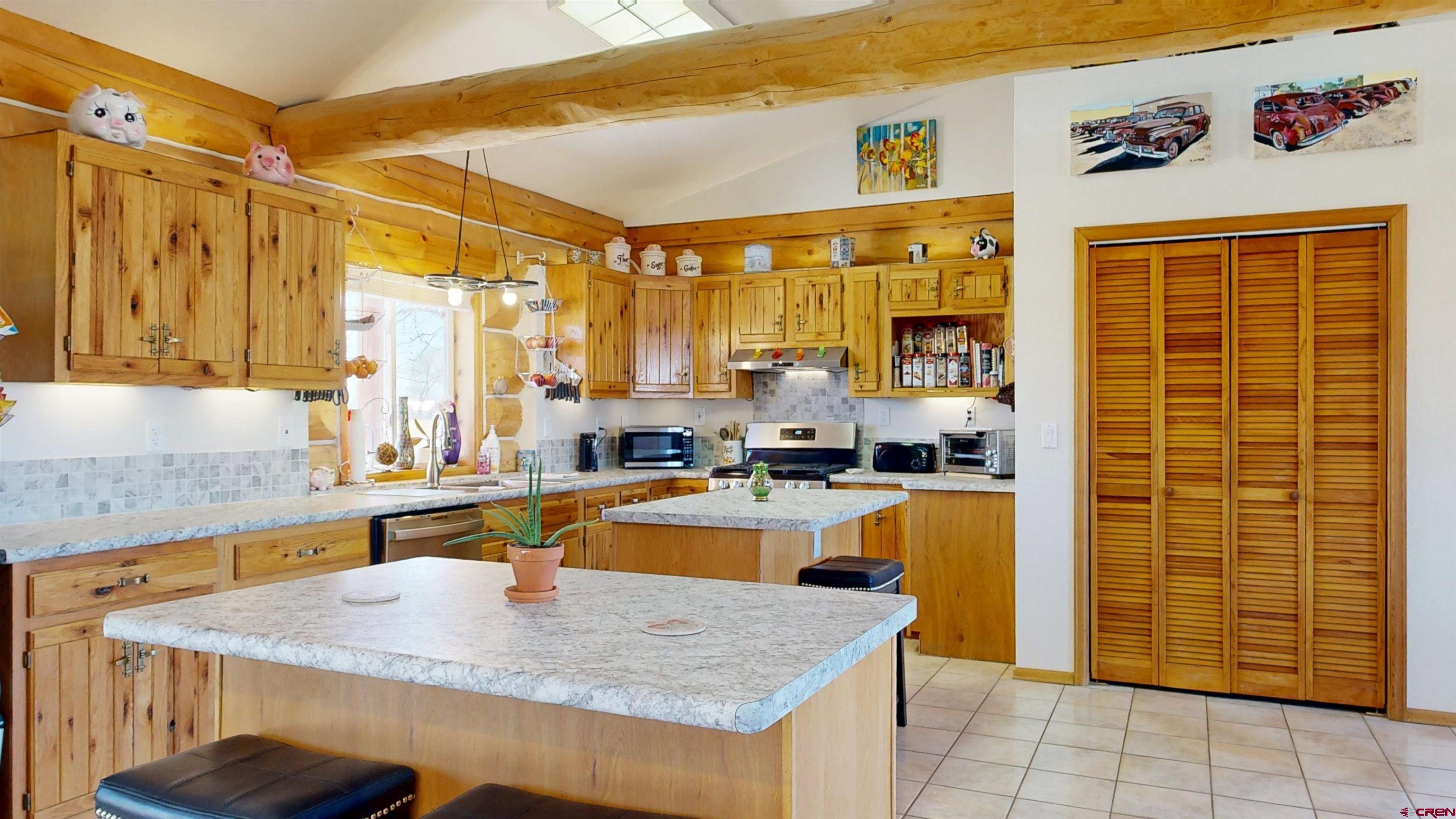 2083 Pioneer Road Delta, CO 81416 - Photo 6 of 43 a kitchen with granite countertop a sink and a refrigerator