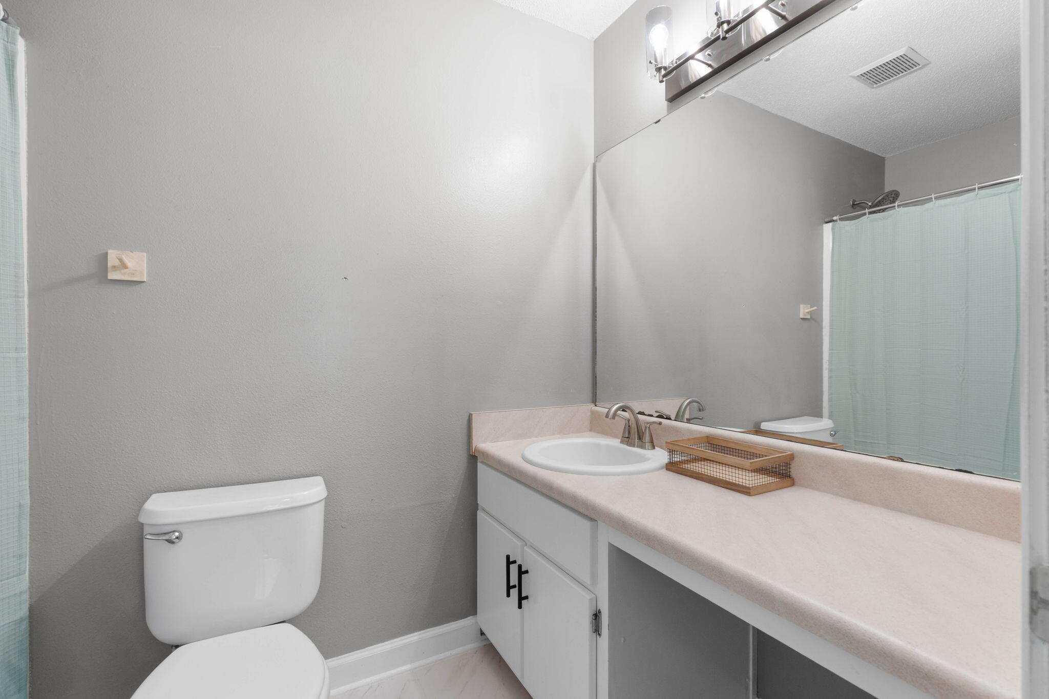 2517 Sunset Drive Crestview, FL 32536 - Photo 23 of 34 a bathroom with a toilet sink and mirror