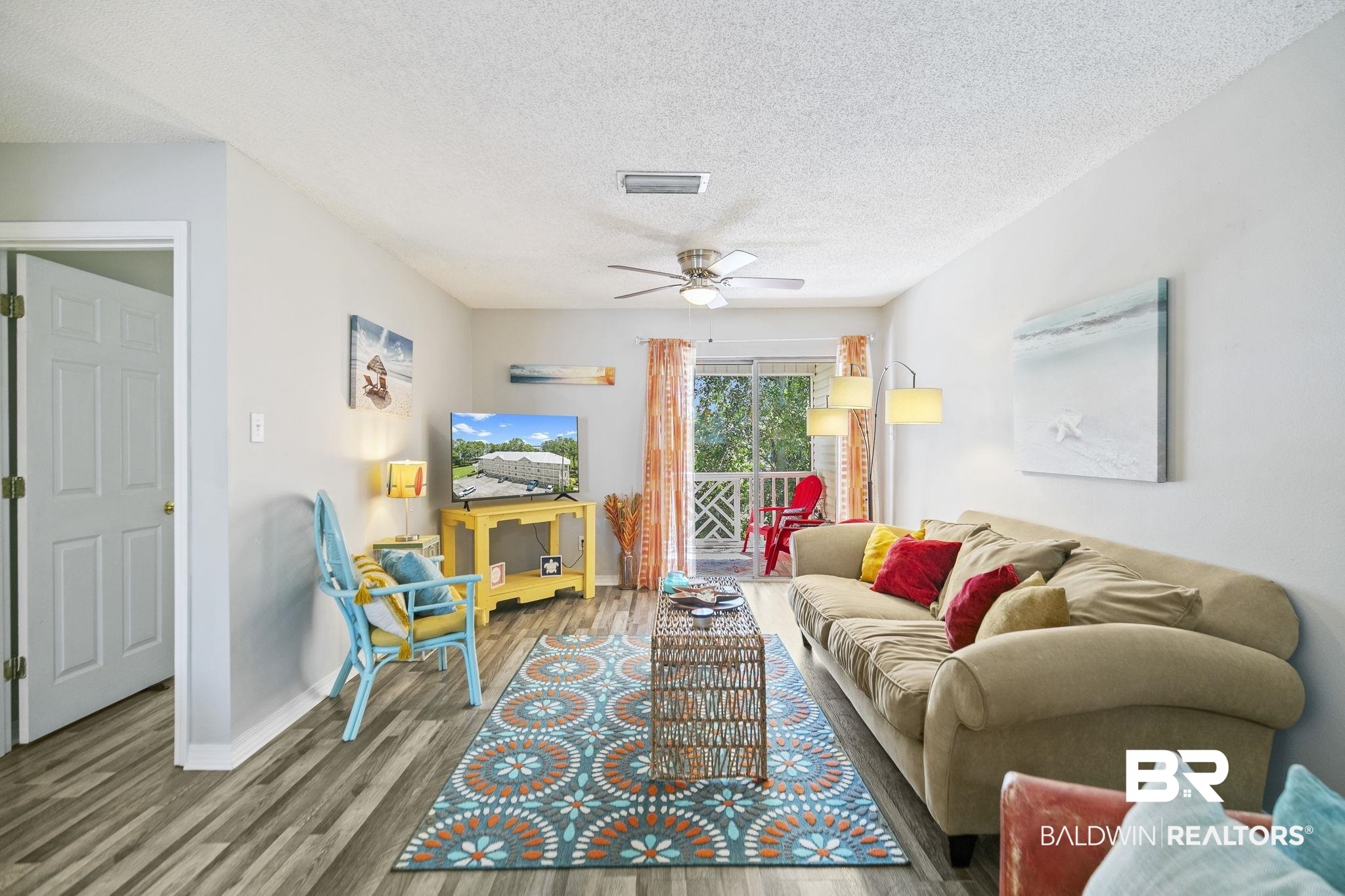 25957 Canal Road, Unit 302 Orange Beach, AL 36561 - Photo 5 of 26 Living room featuring a textured ceiling, ceiling fan, and hardwood / wood-style floors