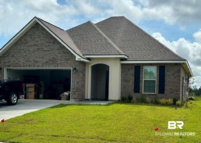 13260 Canebrake Circle Foley, AL 36535 - Photo 1 of 3 Brick exterior residence featuring a two-car garage, covered entry, and a gabled roofline