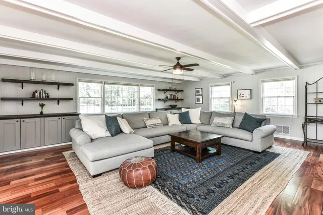 a living room with fireplace furniture and a floor to ceiling window