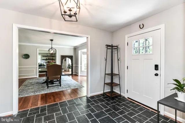 a dining room with stainless steel appliances kitchen island granite countertop a rug a stove and a window