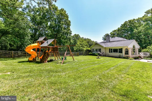 a front view of a house with a yard table and chairs