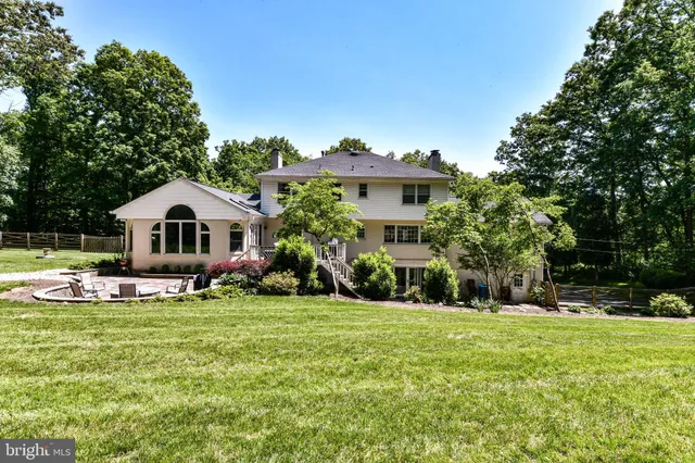 a front view of house with yard and trees around