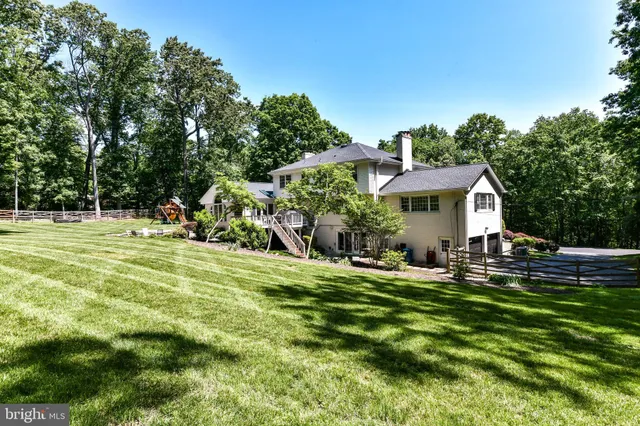 a front view of a house with a yard table and chairs
