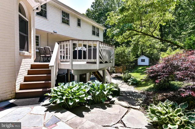 a front view of a house with a yard and a garden