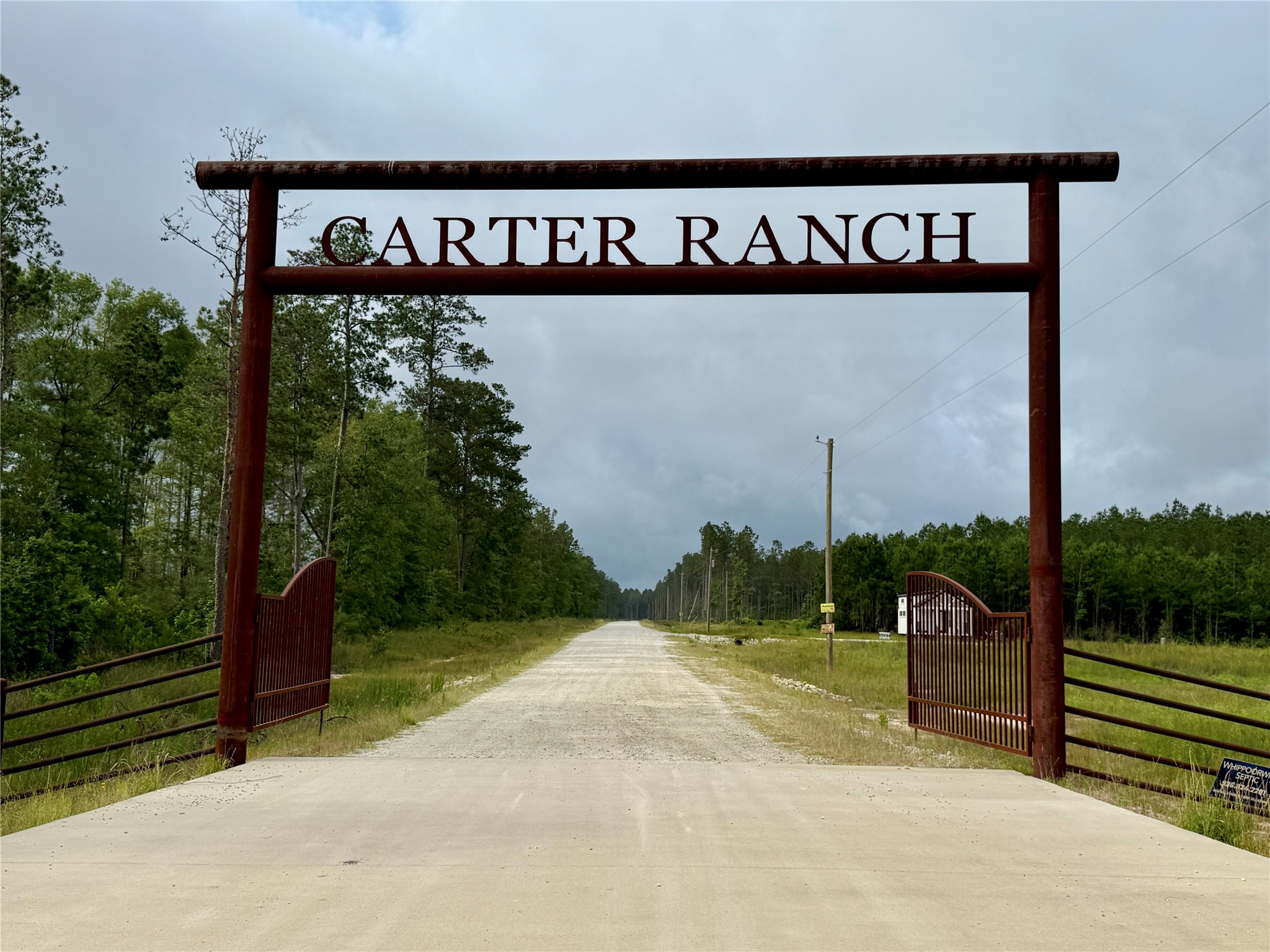 8640 Carter Ranch Road Kountze, TX 77625 - Photo 2 of 5 a street sign on a wall next to a road