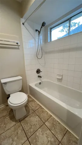 a bathroom with a toilet and a bathtub