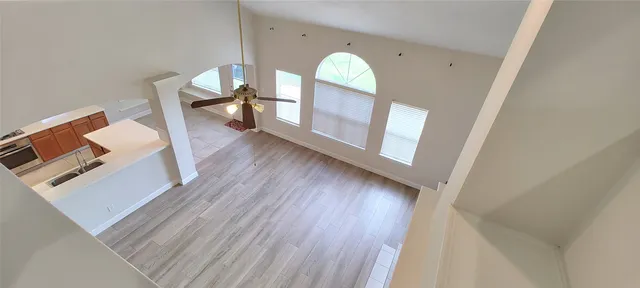a view of a livingroom with wooden floor and a fireplace