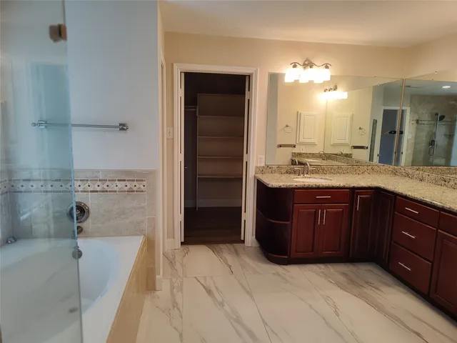 a bathroom with a granite countertop sink a vanity and mirror