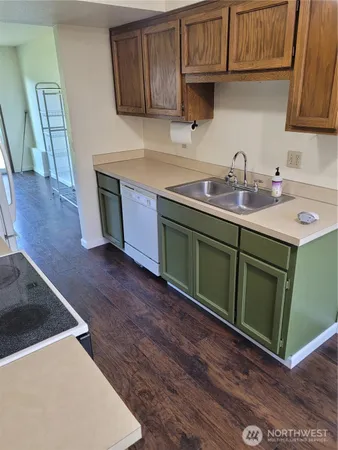 a kitchen with stainless steel appliances granite countertop a sink stove and cabinets