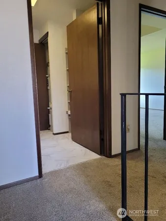 an empty room with sliding door and a window