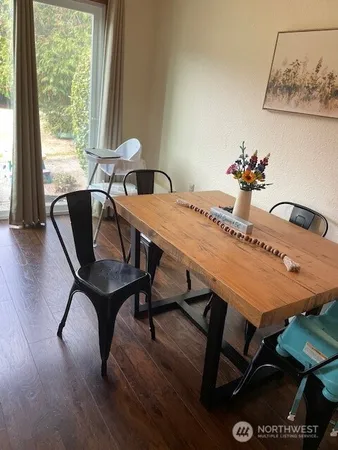 a dining room with furniture and wooden floor