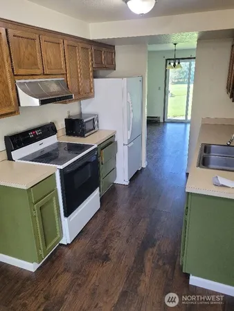 a kitchen with a stove and a refrigerator