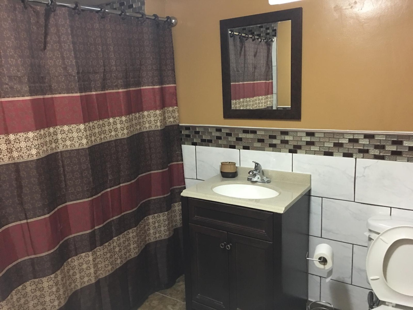 Undisclosed Address Bolingbrook, IL 60440 - Photo 7 of 15 a bathroom with a sink a toilet and mirror
