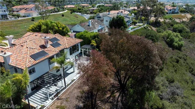 an aerial view of multiple houses with yard