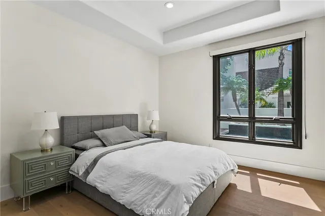 a view of a bedroom with a bed and a chandelier