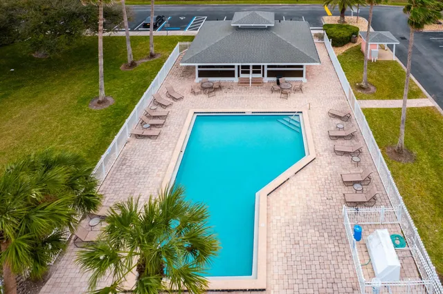 an aerial view of residential houses with outdoor space and street view