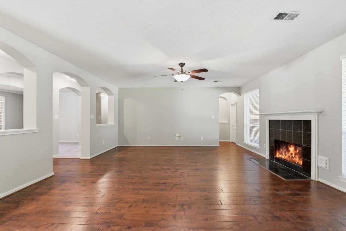 3414 Hackberry Court Spring, TX 77388 - Photo 12 of 50 View from the kitchen through the family room. The primary bedroom is down that small hallway on the right.