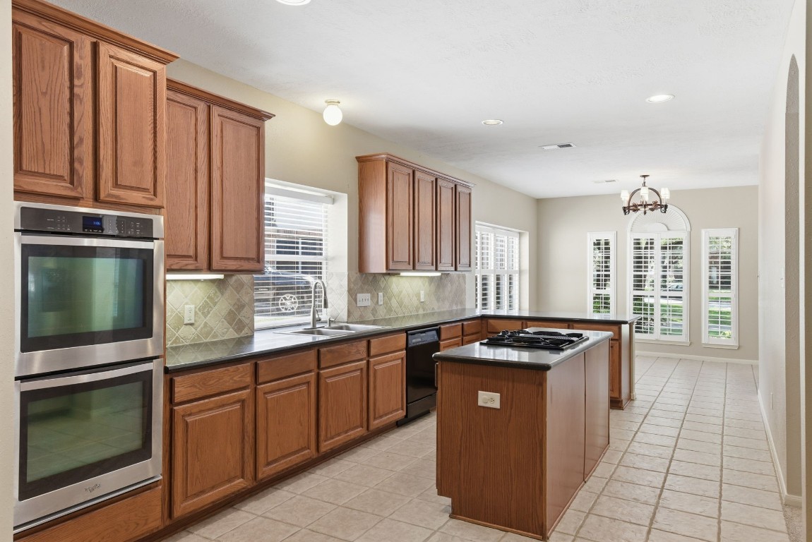 3414 Hackberry Court Spring, TX 77388 - Photo 15 of 50 Look at all of this space and all of the storage! Granite counter tops, tile back splash, tile floors, fresh paint, under cabinet lighting! Breakfast room is at the back of this picture.
