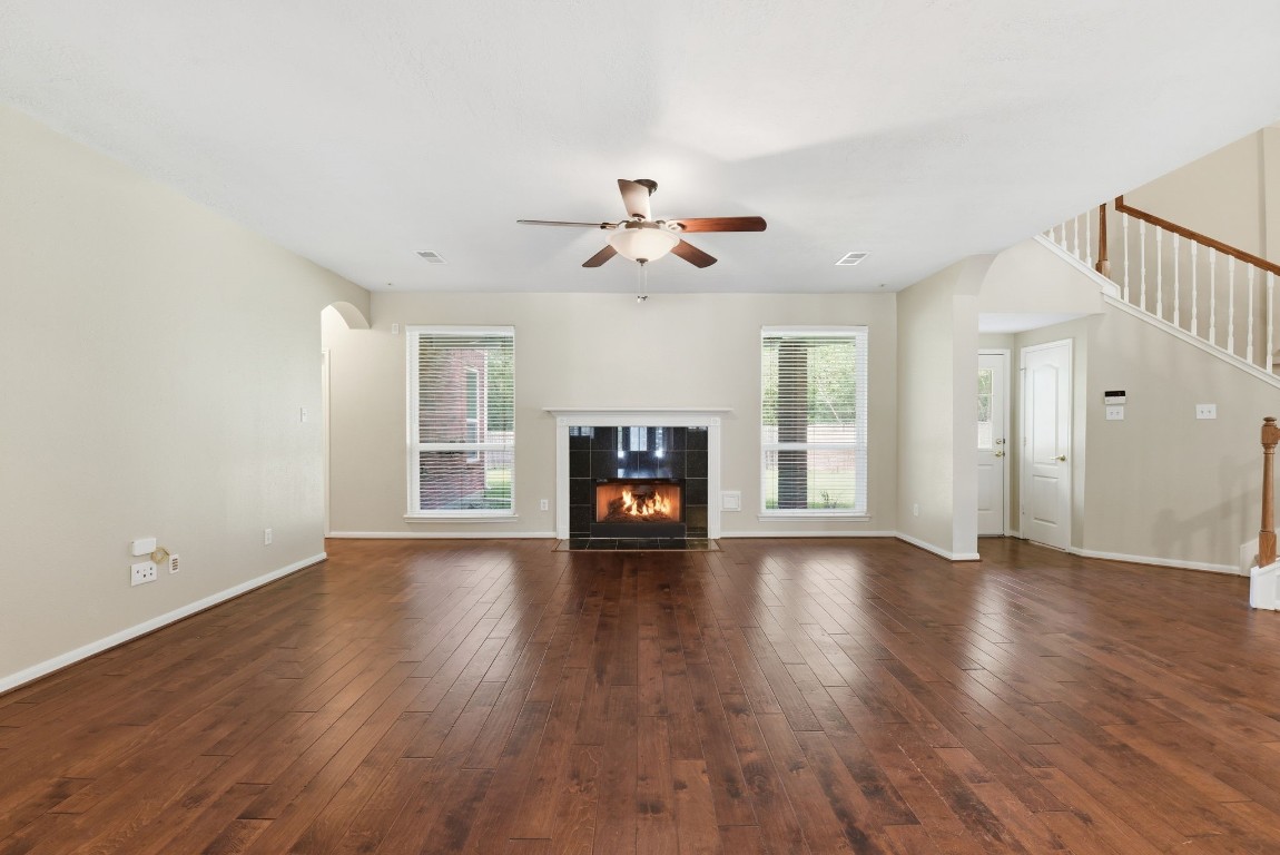 3414 Hackberry Court Spring, TX 77388 - Photo 10 of 50 The family room is the center of the downstairs and is completely open to the kitchen. Wood floors, ceiling fan, fresh paint, gas log fireplace.